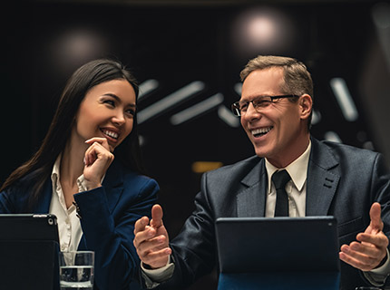 the smiling man and woman sitting at the table on Q8FVJ9V